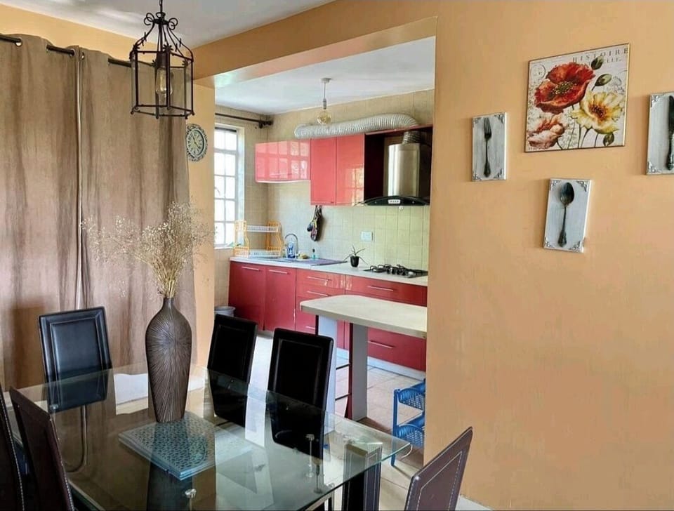 Dining room with open plan kitchen. 
Fridge, Microwave,  Cooker, Kettle, dishes