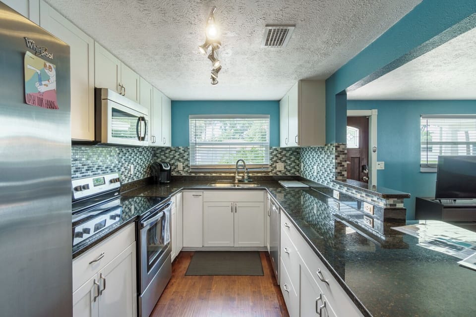 Our kitchen: back splash, stainless steel appliances and granite.