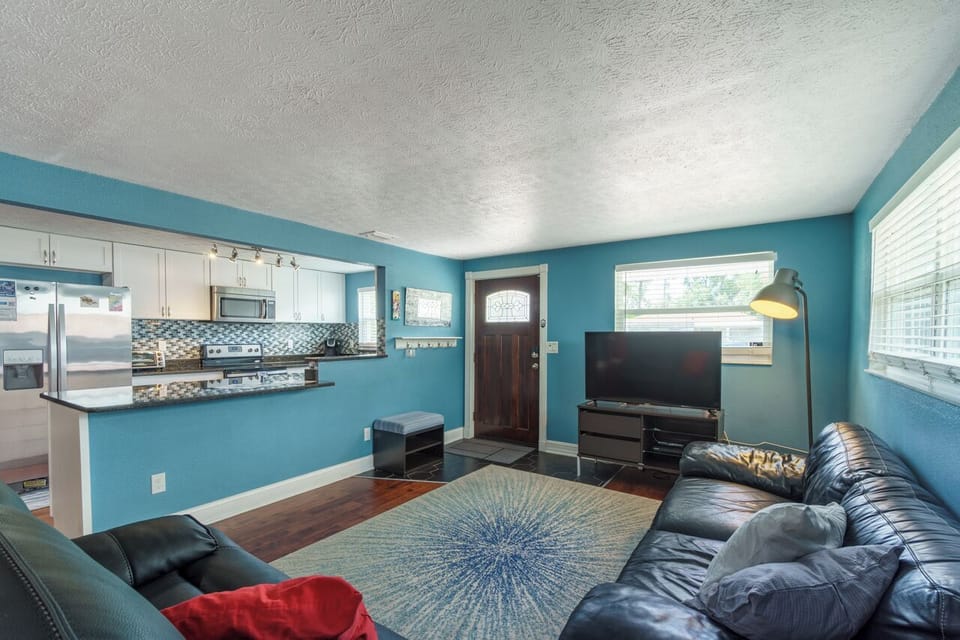 A wide view from our living room with a view of the front door and kitchen!