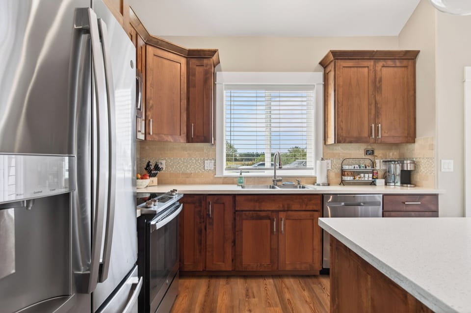 The kitchen is bright and open with a large window—perfect for gathering.