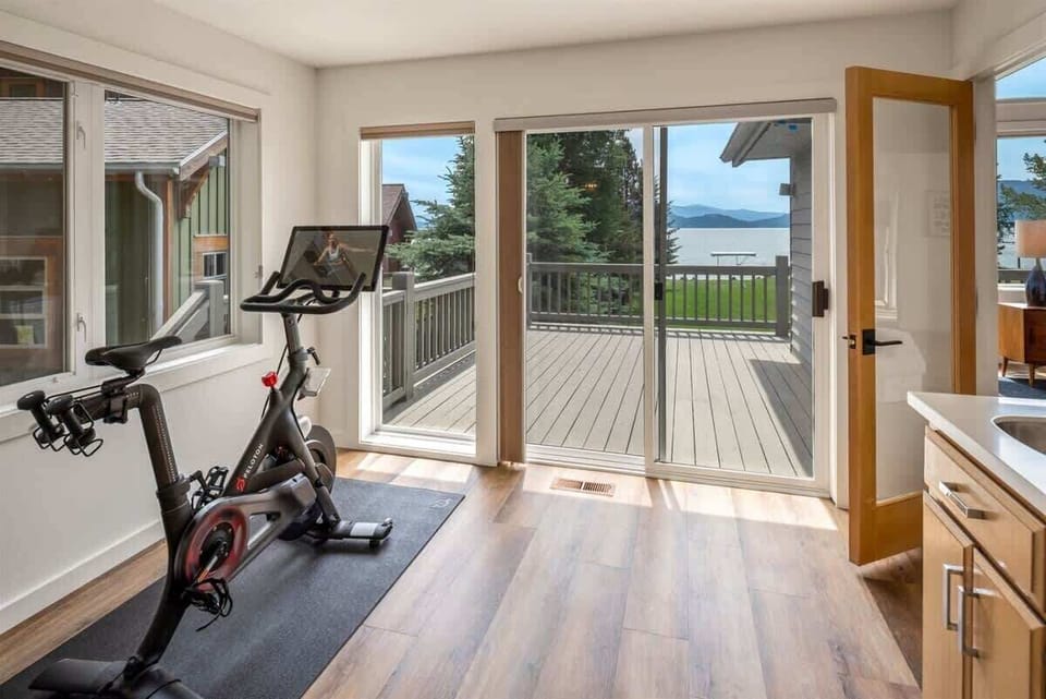 Exercise sun room with new Peloton and Yoga mats and accessories. 