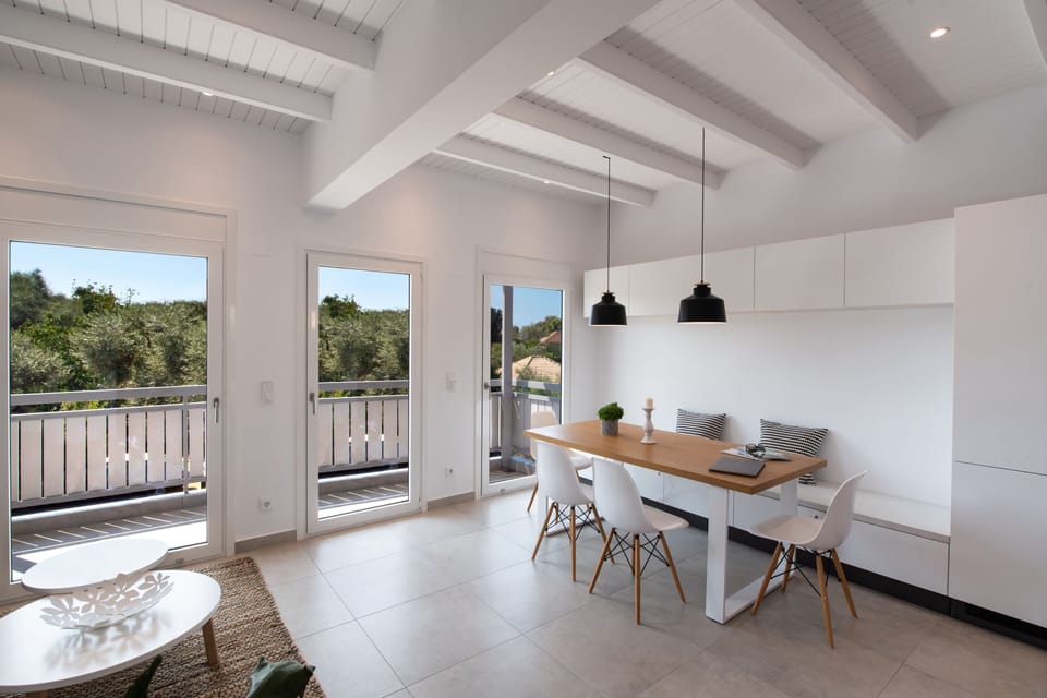 Bright space with a large sitting bench and dinning table
