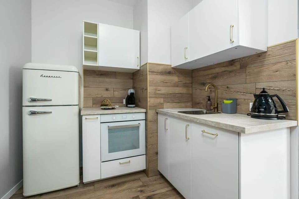 Another perspective of the kitchen, showcasing its efficient use of space and stylish finishes.