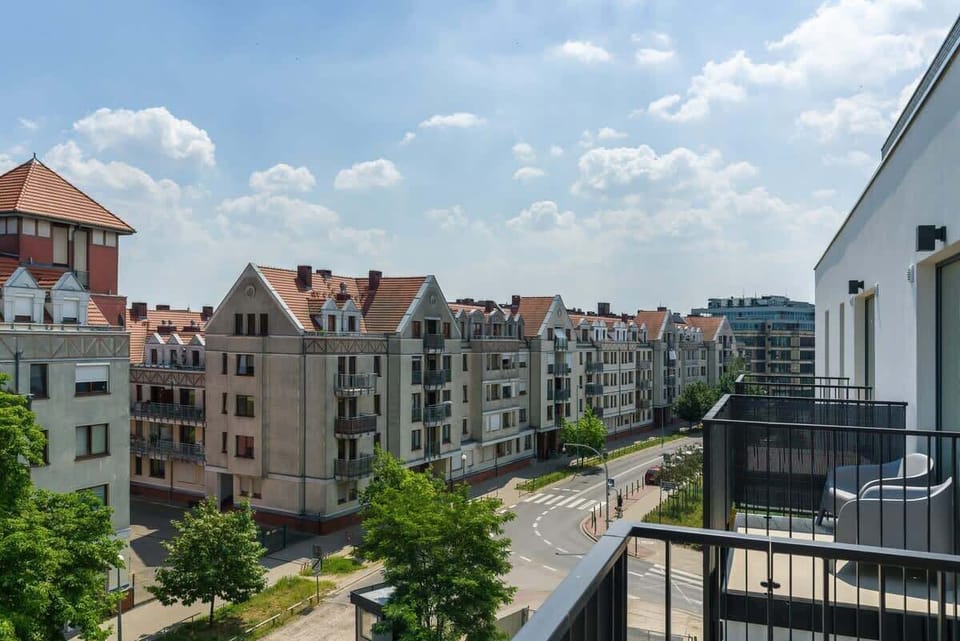 Another angle of the balcony, capturing the expansive views of the residential neighborhood and greenery.