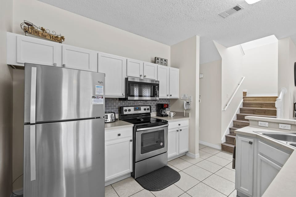 Kitchen with stainless steel appliance