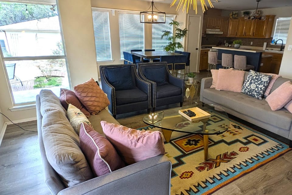 Lots of seating in living room, dining area and countertop in kitchen