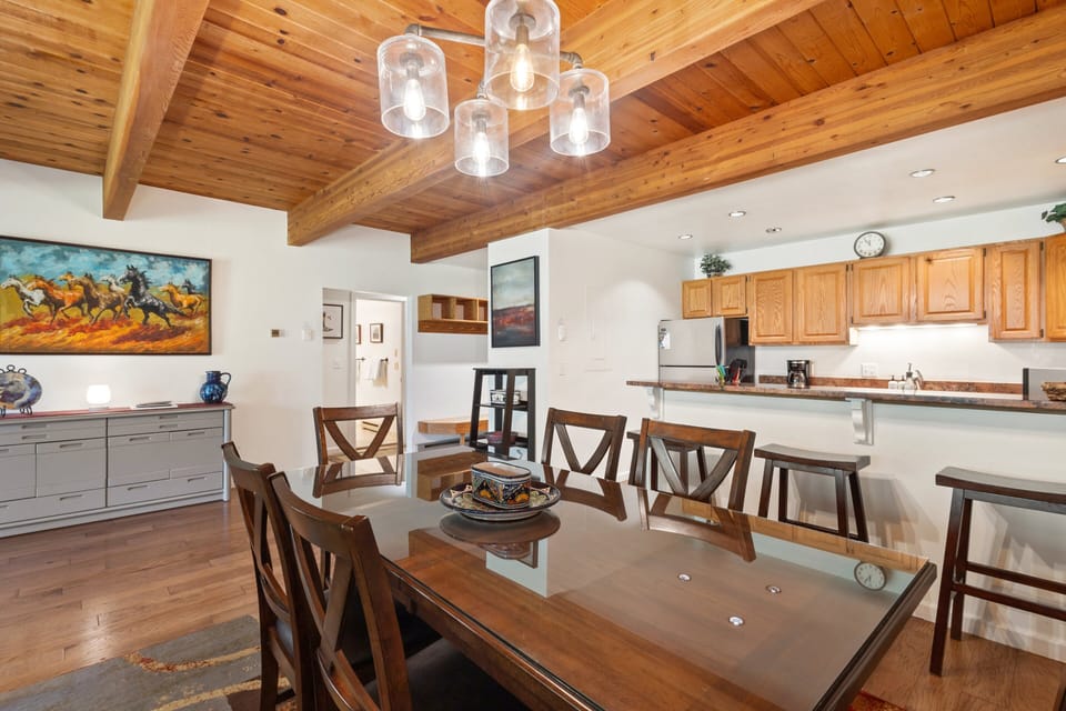 There is a dining room table for six and breakfast bar with seating for three.