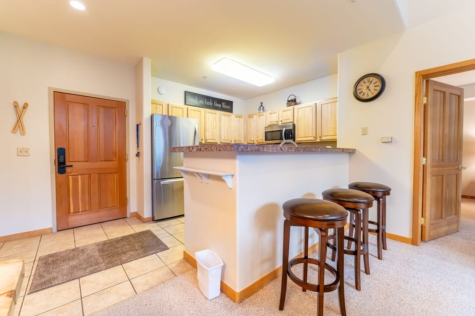Your spacious kitchen features granite counters, stainless appliances, and a breakfast bar where you can start your day with coffee.