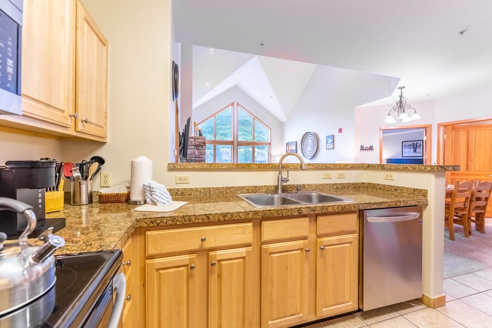 Your spacious kitchen features granite counters, stainless appliances, and warm wood cabinetry - perfect for preparing meals together.