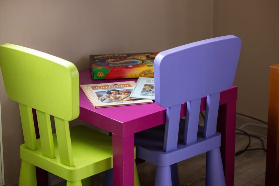 A children's corner in the living room with colorful chairs and a small table, adding a family-friendly touch.