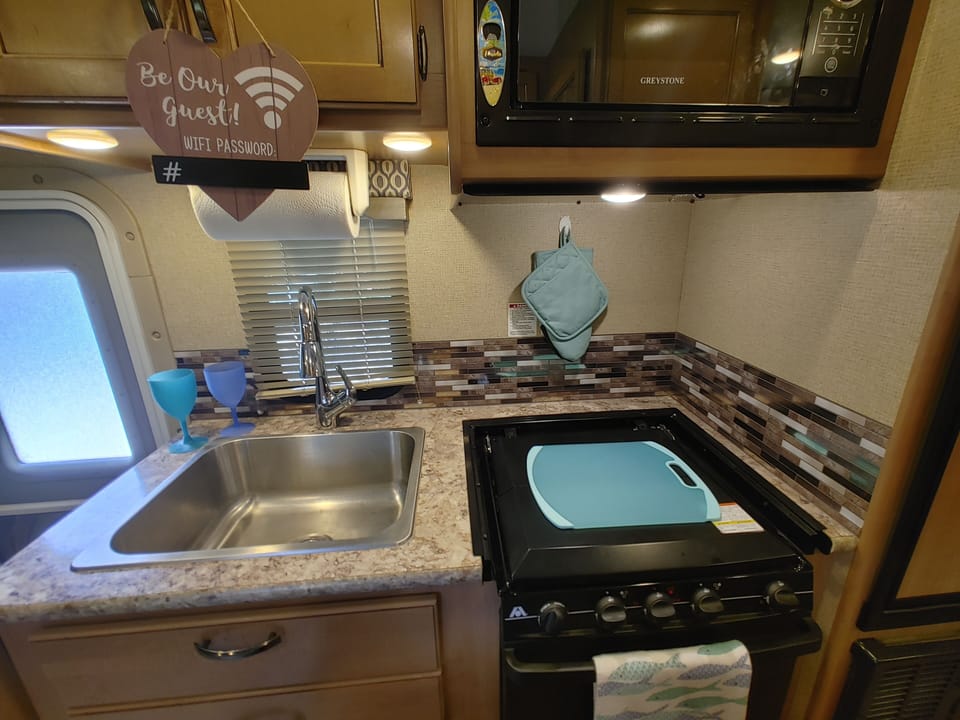 Kitchen has paper plates, cutlery, cups, pots/pans, utensils, can opener.