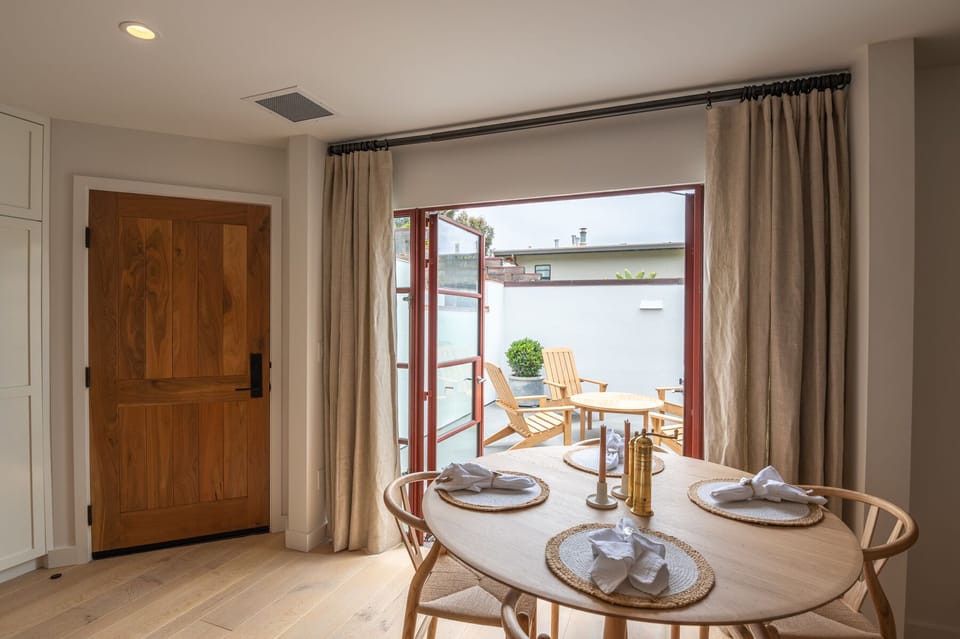 Dining for four. The kitchen area is fully equipped for cooking meals. 