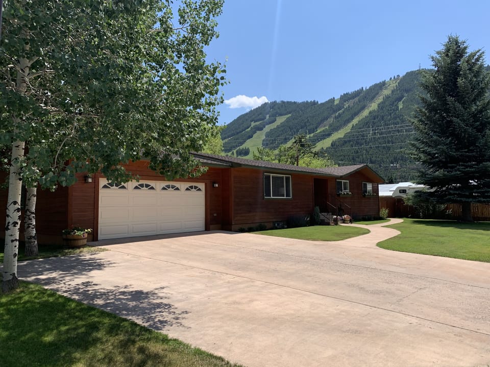 Front of house with Snow King in the background.
