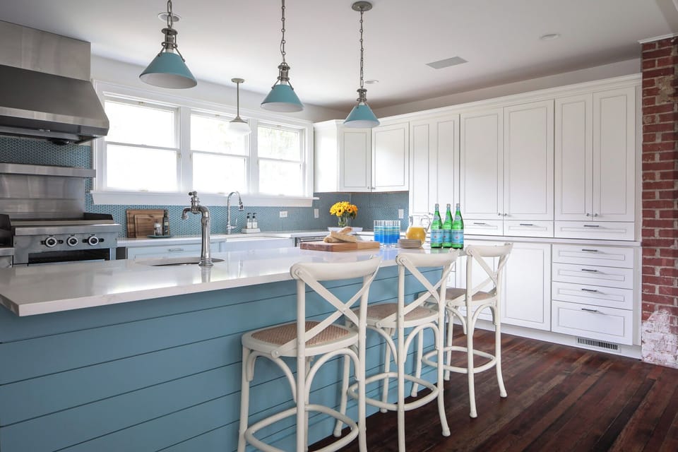 Kitchen with large subzero fridge and professional garland stove.  Large island.