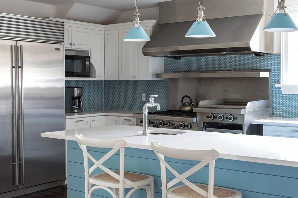 Kitchen with large subzero fridge and professional garland stove.  Large island.