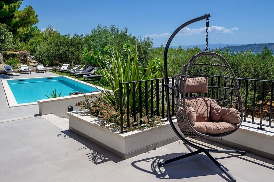 Hanging swing chair for relaxing in the sun of the luxury villa for vacation and rent