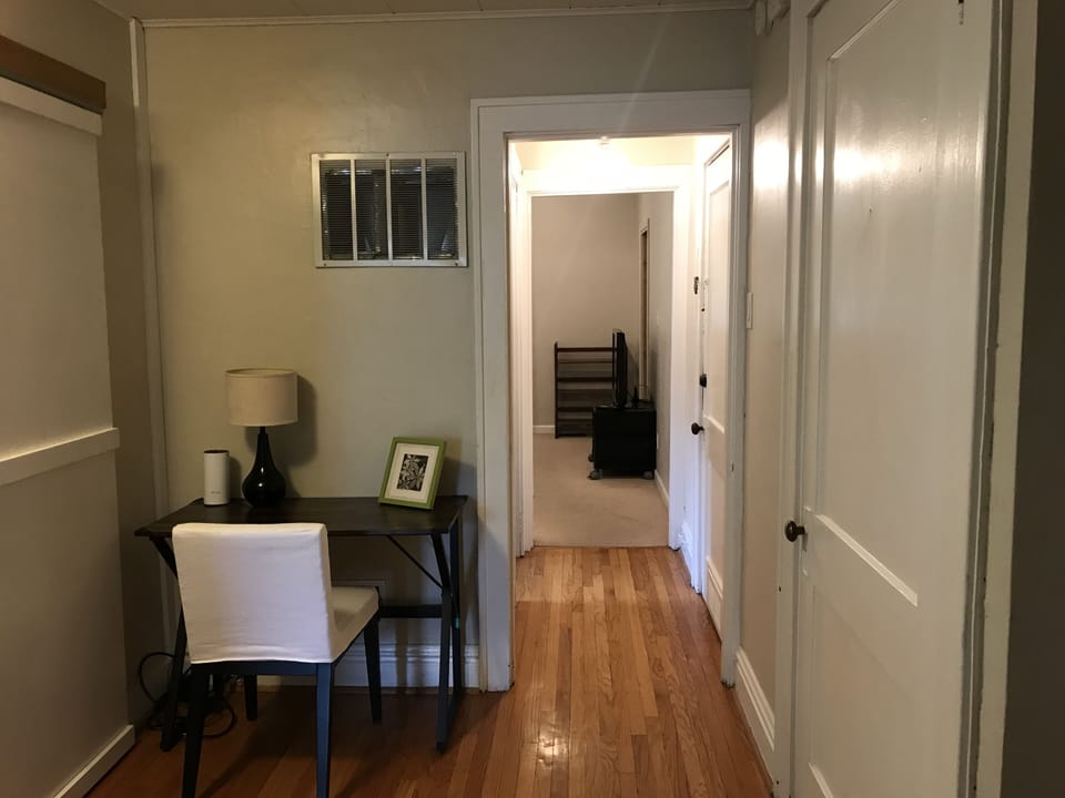 Loft room view of desk & chair. Back bedrooom & second floor full bath.