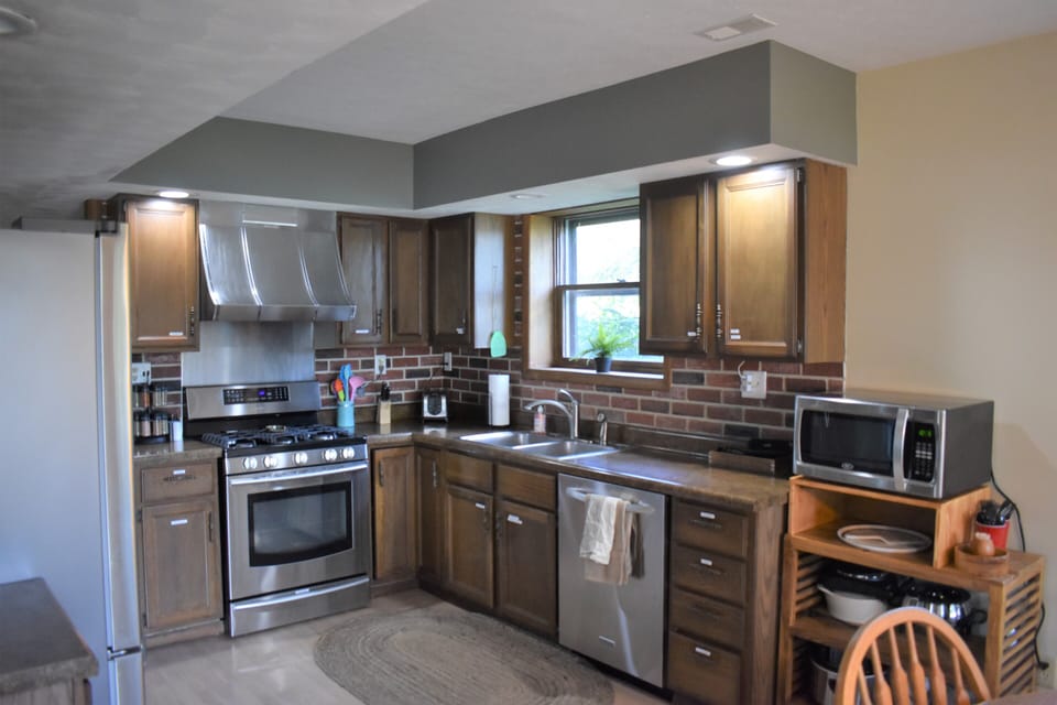 Kitchen has stainless steel fridge/freezer, oven/stove, dishwasher and microwave