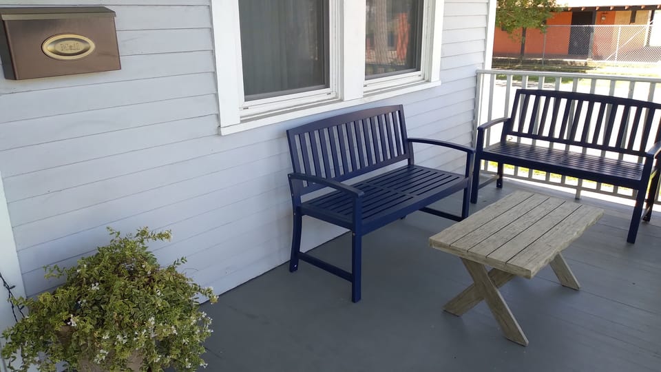 Our front porch is a place for morning coffee and shelter coming and going.