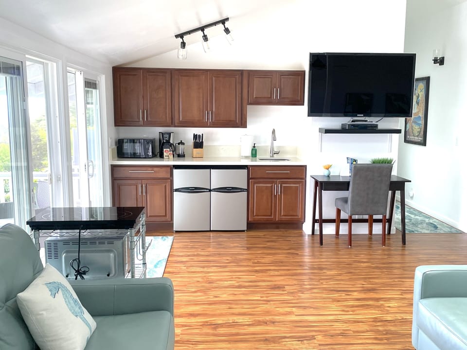Kitchenette has several appliances including a double electric cooktop, toaster