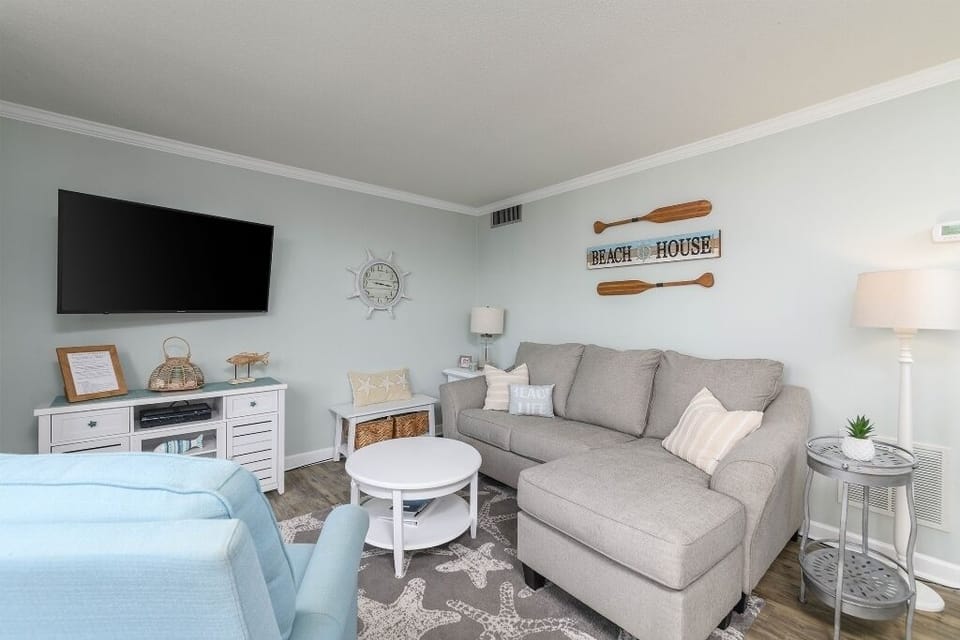 Living room with new sofa queen sleeper (Jan. 2024), recliner, big screen tv