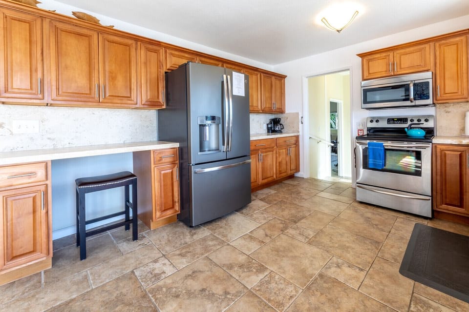 kitchen includes many appliances: dishwasher, oven, microwave oven, coffee maker