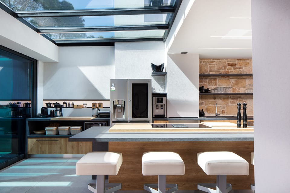 First floor kitchen accompanied by 5 bar stools