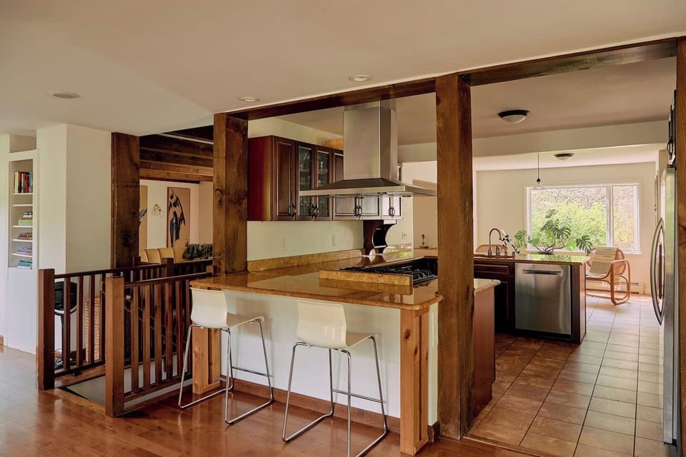 Kitchen // Open floor plan- kitchen, (2) breakfast bars, and dining room. Kitchen stocked with anything you might need for cooking up a feast. 