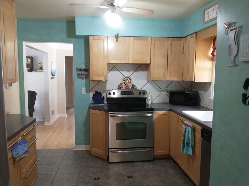 The kitchen is full of everything you need, spices, pots and pans, baking dishes