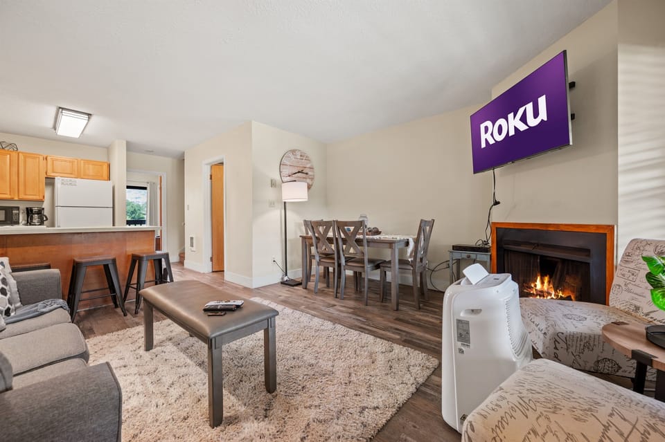 The open-concept living space, complete with a dining area, facilitates effortless conversation with family and friends.