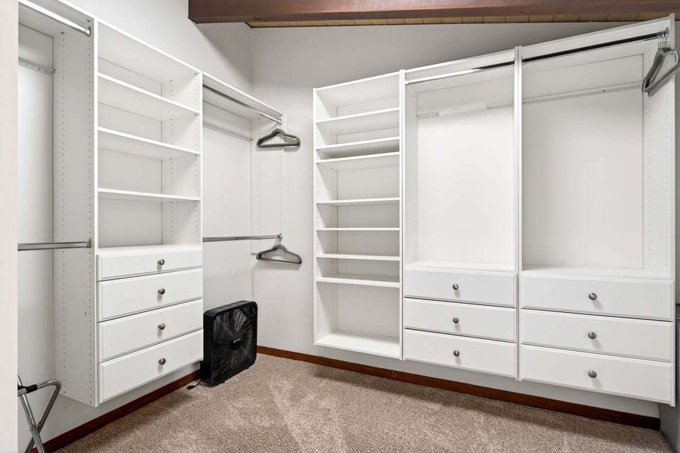 Bedroom closet adjacent to the king bedroom with luggage racks, extra blankets, and hangers. Everything you need for a restful stay.
