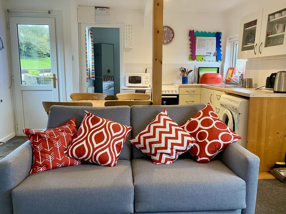 Trehanoo annexe sitting room looking towards kitchen area (new sofa bed 2023)