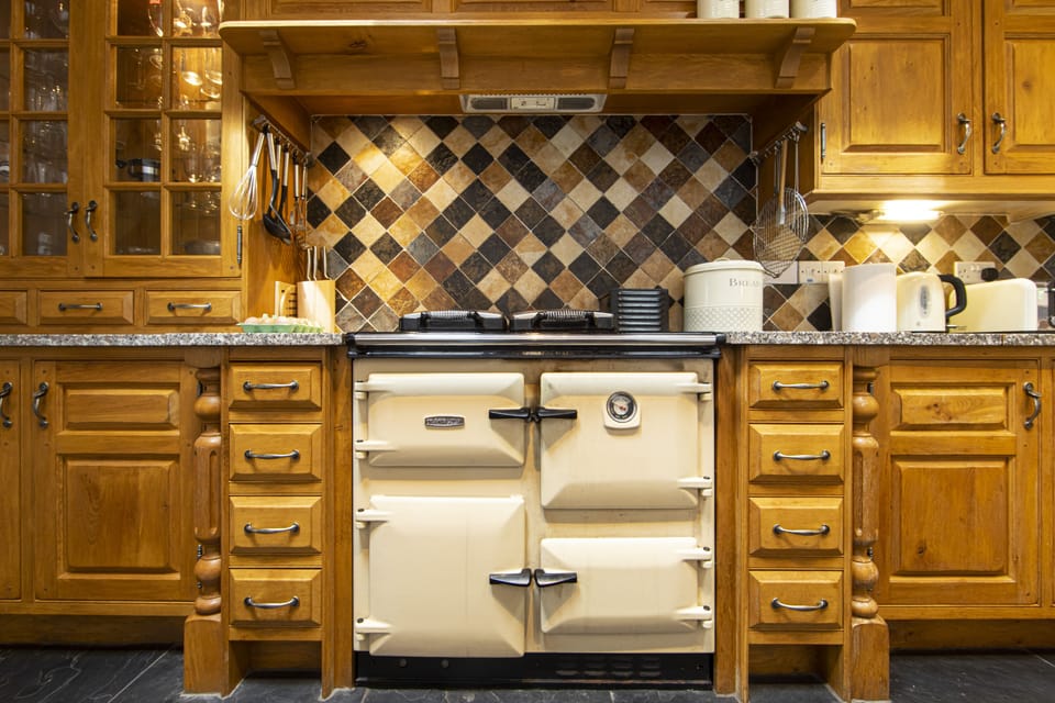 Rayburn cooker in handmade oak kitchen
