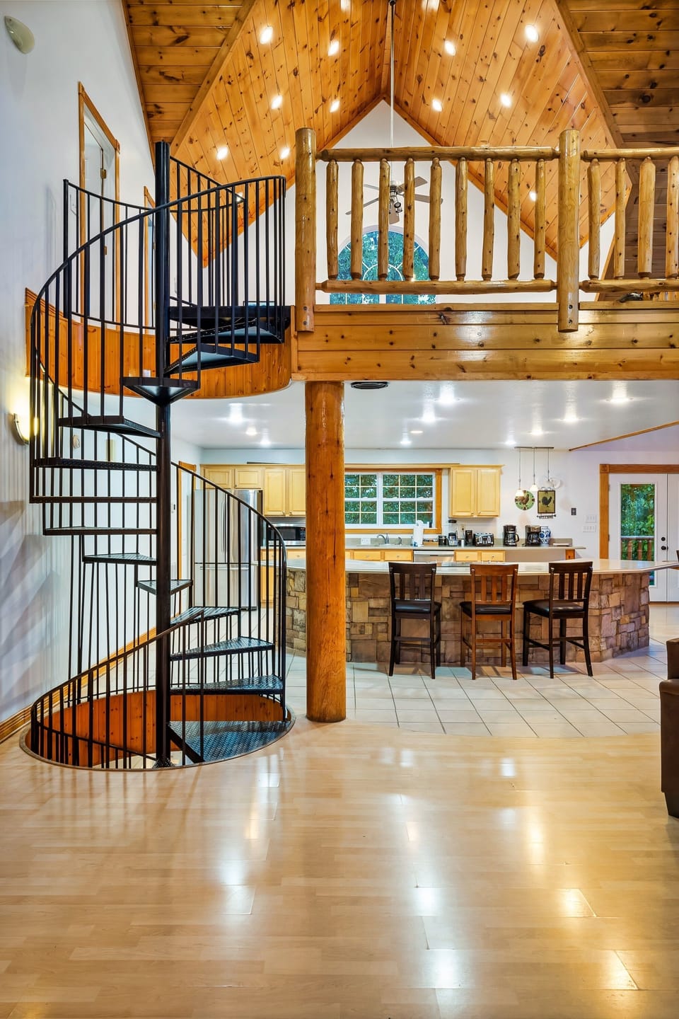 Spiral staircase leads to the loft bedroom, bathroom and down to game room