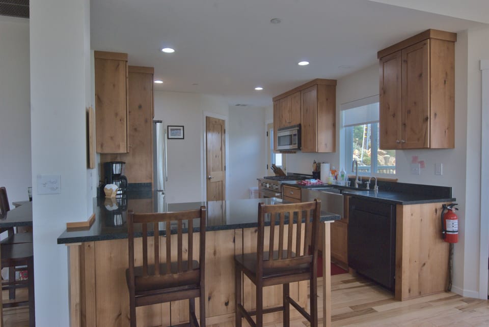 The modern kitchen features granite counters and a breakfast bar