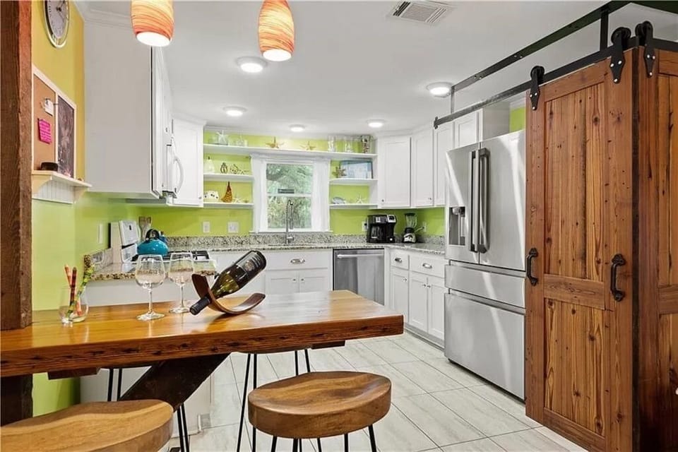 Beautiful kitchen with barn door enclosed washer and dryer