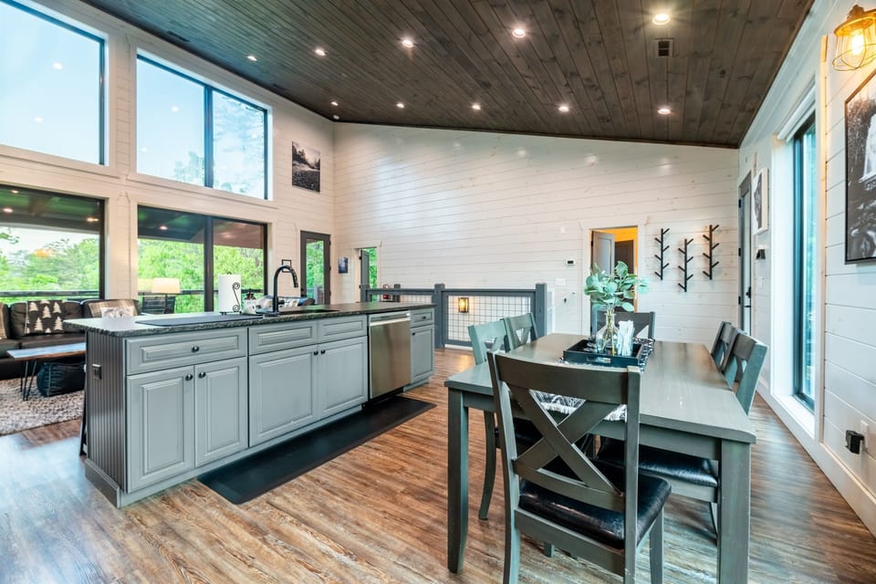 Fully stocked kitchen, dining table and large expansive open layout and windows