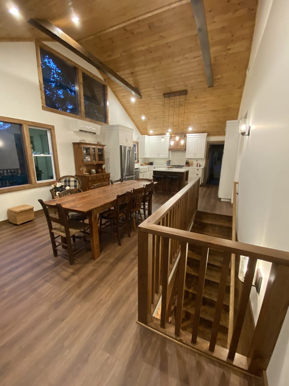 Open kitchen and dining room with farmhouse table and plenty of natural light