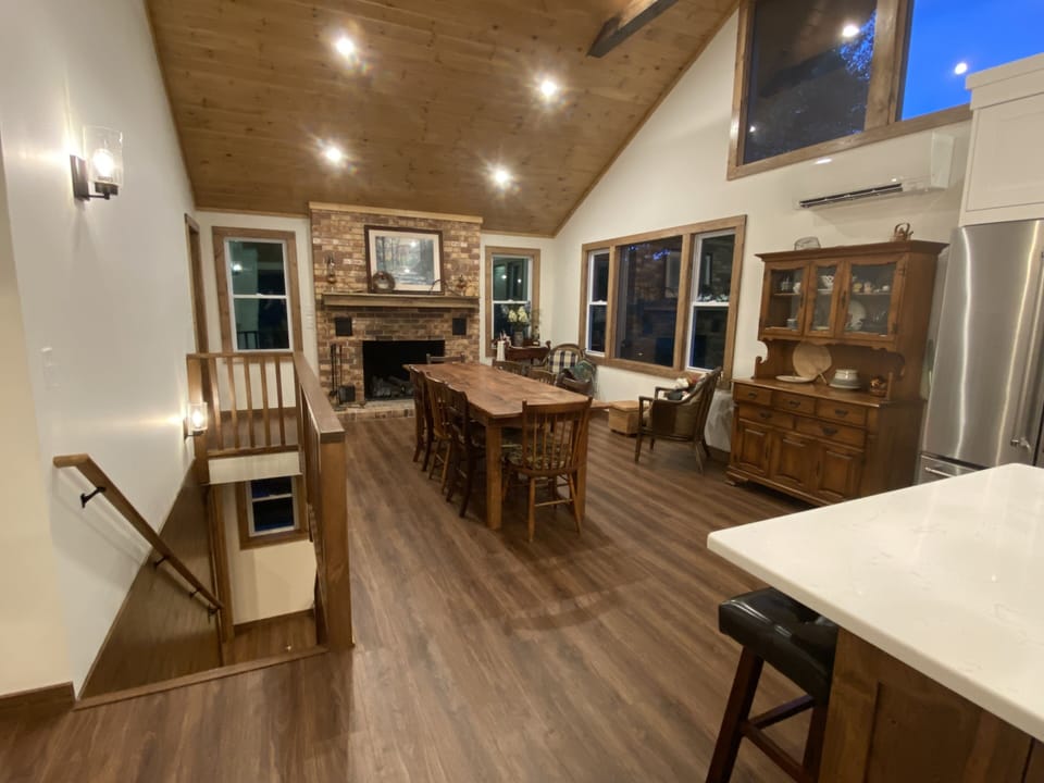 Open kitchen/dining room with vaulted ceiling, rustic beams and gas fireplace!