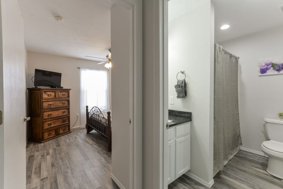 View of second bathroom and into the 3rd queen bedroom