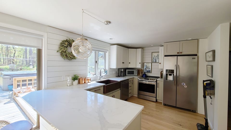 Kitchen with stainless appliances and counter seating
