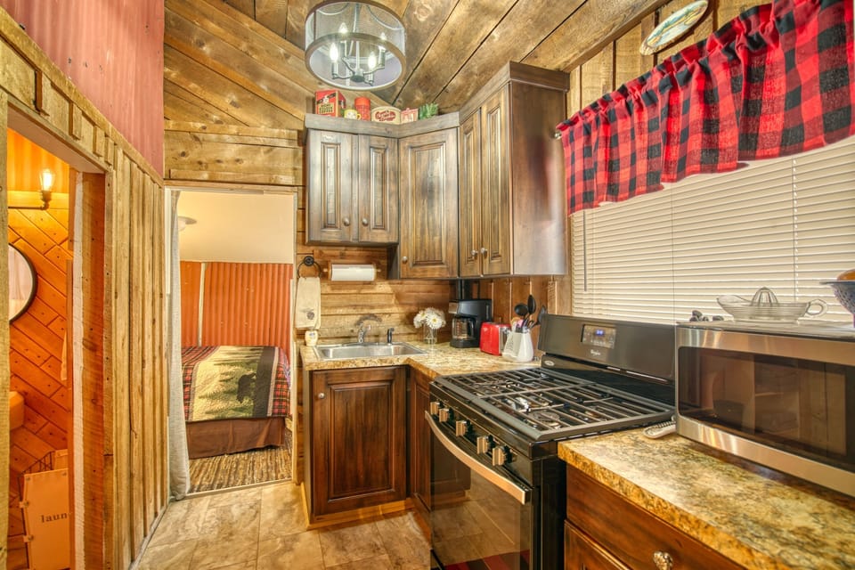 Well stocked kitchen with full size appliances including five burner gas stove.