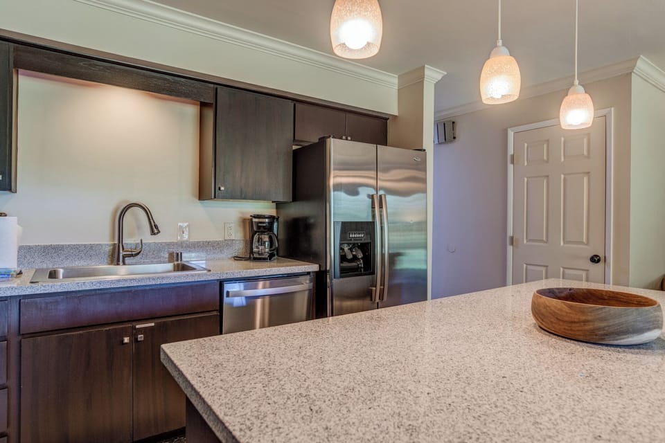 Modern chef-ready kitchen with granite countertops and a central island for easy meal prep or morning coffee.