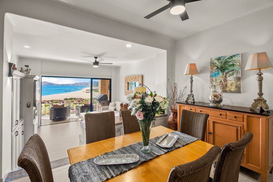 Renovated kitchen with bar seating, 6-seat dining table and ocean views.