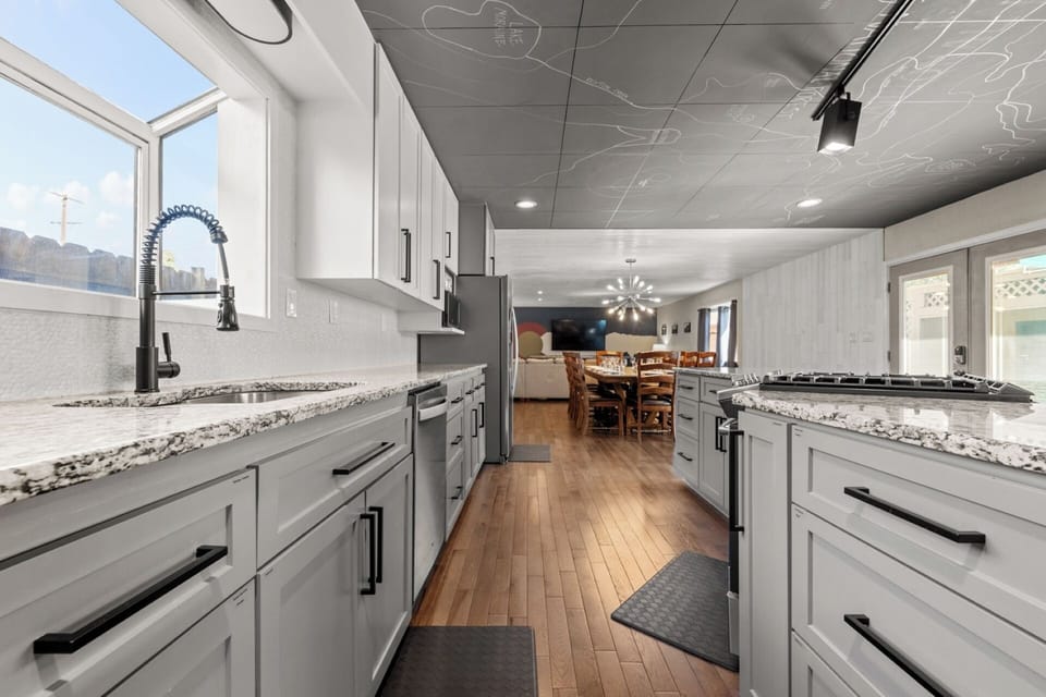Fully stocked chef kitchen - granite counter, gas range, huge island, stainless