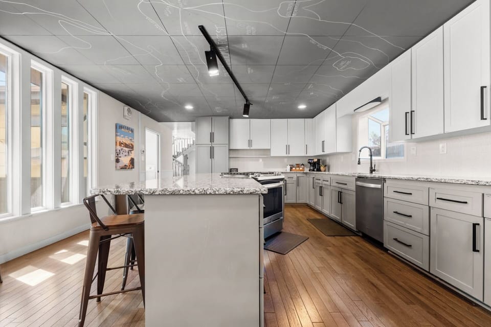 Fully stocked chef kitchen - granite counter, gas range, huge island, stainless