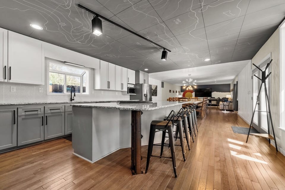Fully stocked chef kitchen - granite counter, gas range, huge island, stainless