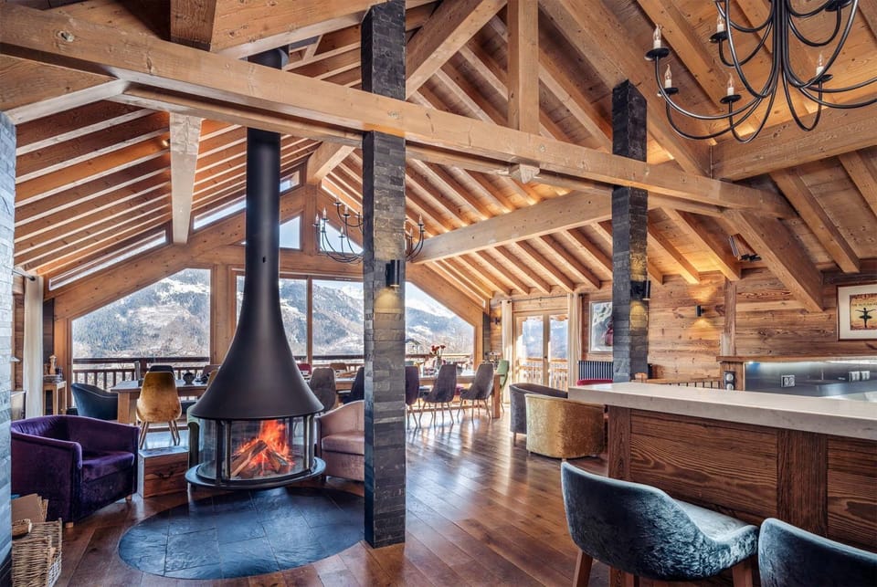 Rustic wooden living area centred around a wood-burning fireplace