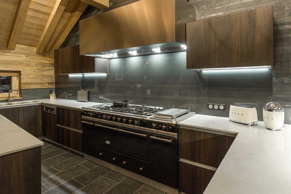 Sleek kitchen with dark cabinetry and high-end stainless steel appliances