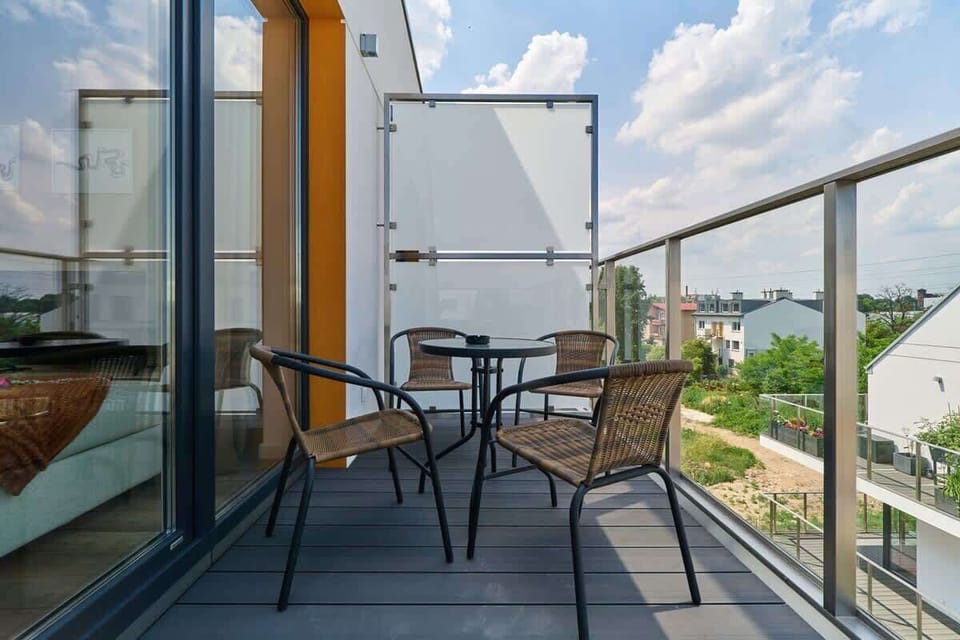 A spacious balcony with outdoor seating, perfect for enjoying sunny days and fresh air.